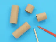toilet paper tubes cut to different sizes next to a pencil.